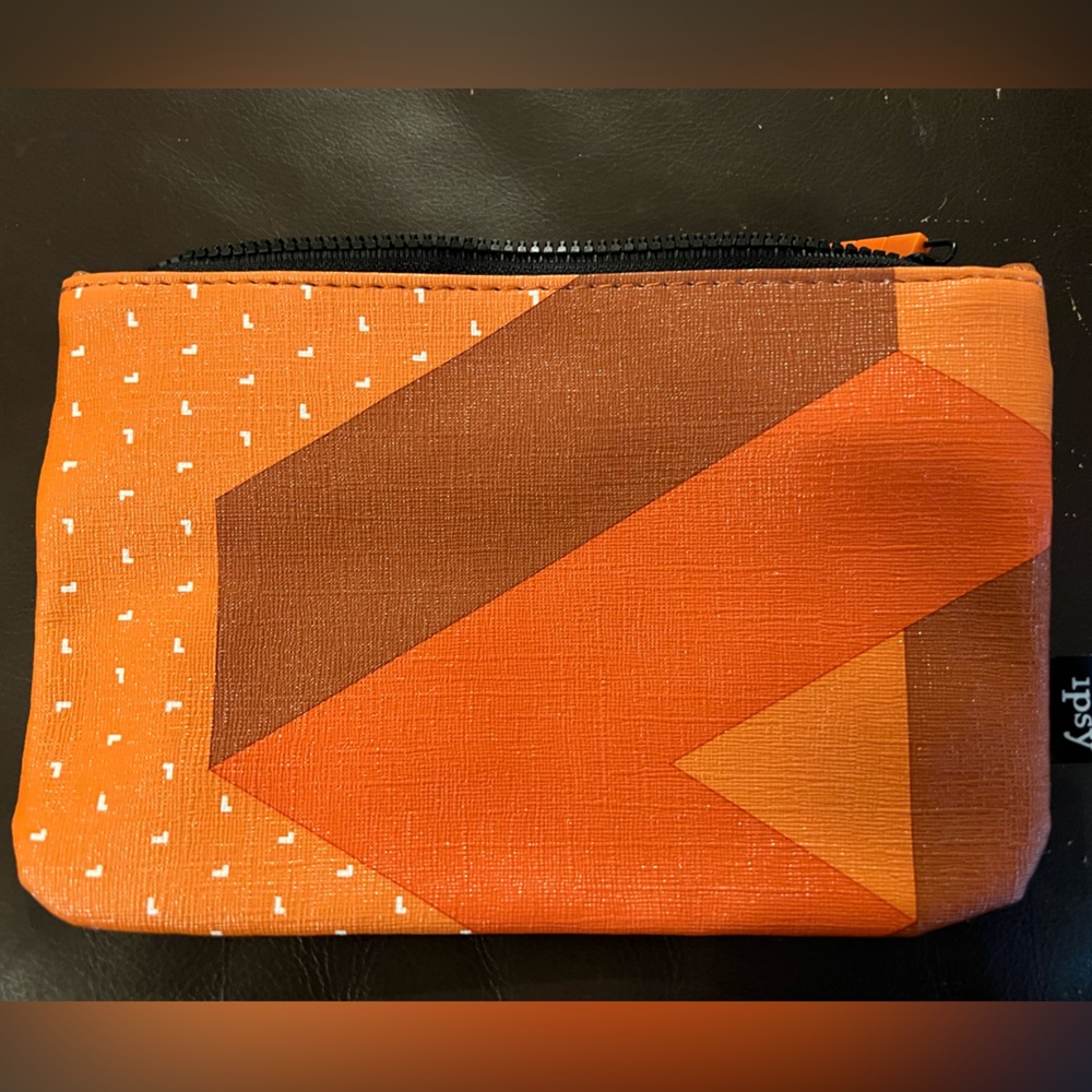 Ipsy makeup bag zipped. Orange brown black